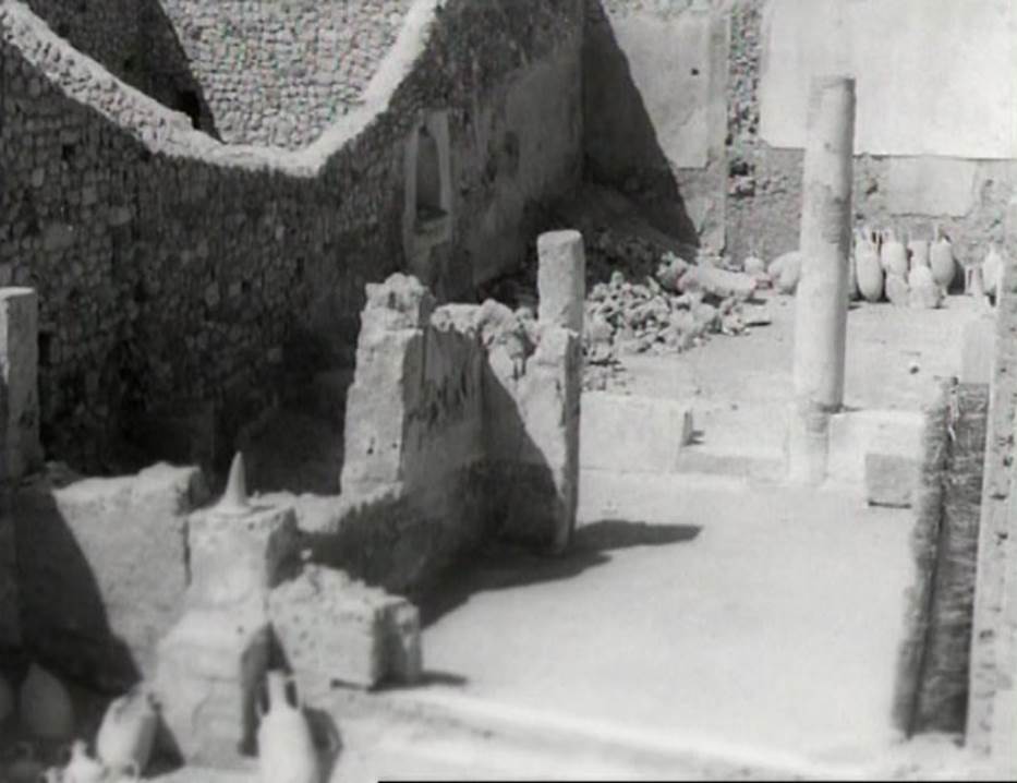 I.9.12 Pompeii. Photo taken in 1954, shortly after excavation.
Looking north through tablinum towards garden area/peristyle. Note the lararium niche on the west wall.