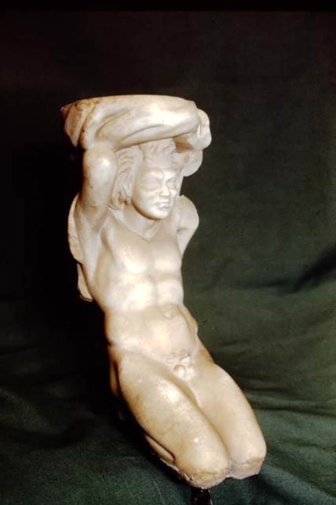 II.2.2 Pompeii. 1978.
Room “k”, marble kneeling Telamon in the form of a kneeling satyr. SAP inventory number 2891.
According to Wilhelmina, this was found on the terrace, but according to Spinazzola, possibly stood in the aedicula, and that water may have splashed from the basin which the statuette supported on its shoulders. However, Dr. Salza Prina Ricotti pointed out that, at least today, there is no evidence of pipes to justify it as a fountain.
Source: The Wilhelmina and Stanley A. Jashemski archive in the University of Maryland Library, Special Collections (See collection page) and made available under the Creative Commons Attribution-Non Commercial License v.4. See Licence and use details.
J78f0158
See Jashemski, W. F., 1993. The Gardens of Pompeii, Volume II: Appendices. New York: Caratzas, (p.78-80).