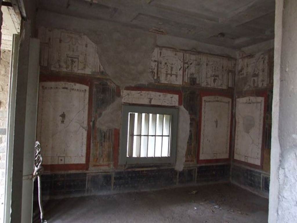 II.2.2 Pompeii. December 2006. Room “f”, Oecus of west side of pseudoperistyle, looking south.
According to Garcia y Garcia, this room also suffered due to the bombing of 19th September 1943.
Partly damaged was the south wall of the white oecus in IV Style.
The other walls also suffered from the fall and partial loss of the painted stucco, which was largely saved and restored from numerous small fragments.
See Garcia y Garcia, L., 2006. Danni di guerra a Pompei. Rome: L’Erma di Bretschneider. (p.45-47).
Kuivalainen describes the upper central figure as partially destroyed, and comments –
“Young sitting Bacchus, on account of the pose and the thyrsus. The decoration clearly indicates cultic purposes.”
See Kuivalainen, I., 2021. The Portrayal of Pompeian Bacchus. Commentationes Humanarum Litterarum 140. Helsinki: Finnish Society of Sciences and Letters, (p.102, B15).