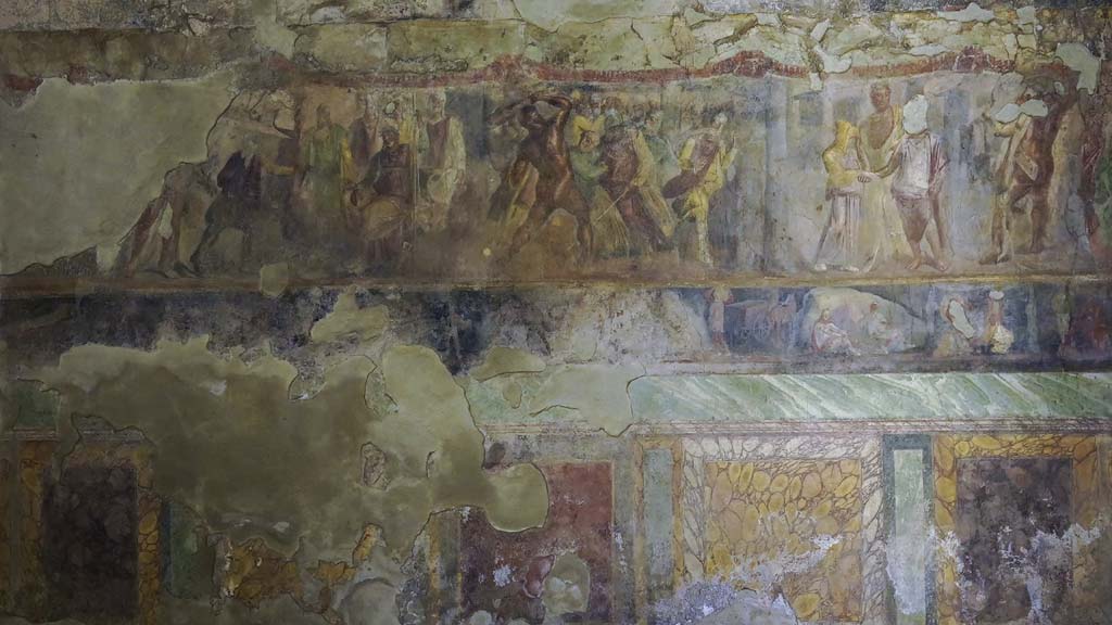 II.2.2 Pompeii. August 2021. Room “h”, detail from painted decoration on east wall. Photo courtesy of Robert Hanson.
The upper section depicts Hercules’ battle with and the killing of Laomedon, King of Troy.
The narrower lower section shows stories from the Trojan War featuring Achilles.