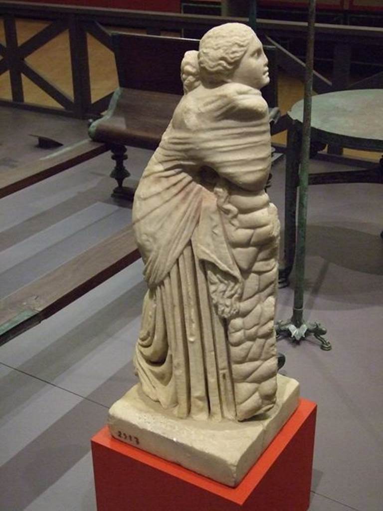 II.2.2 Pompeii. Room “i”. Statue of the muse Polyhymnia. SAP 2917. There were nine goddesses who presided over the arts and sciences. Polyhymnia was the muse of lyric poetry and singing. The statue was one of several on bases between the pillars of the portico. Photographed at “A Day in Pompeii” exhibition at Melbourne Museum. September 2009. Jashemski describes the two surviving statues as, one of Polyhymnia (SAP 2917) and the second of Mnemosyne (SAP 2909). The names on her photographs however are reversed. See Jashemski, W. F., 1993. The Gardens of Pompeii, Volume II: Appendices. New York: Caratzas. (p. 80-1, Figs 84-85).