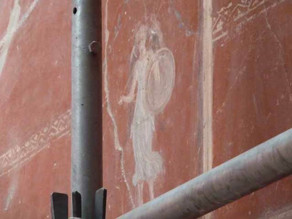 IX.12.9. May 2010. Room 3, south wall, upper zone, centre. Painting of figure with shield.